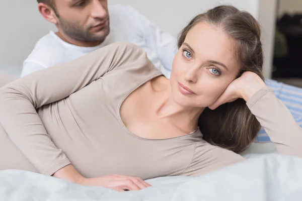 Boyfriend and girlfriend lying on bed — Stock Photo, Image