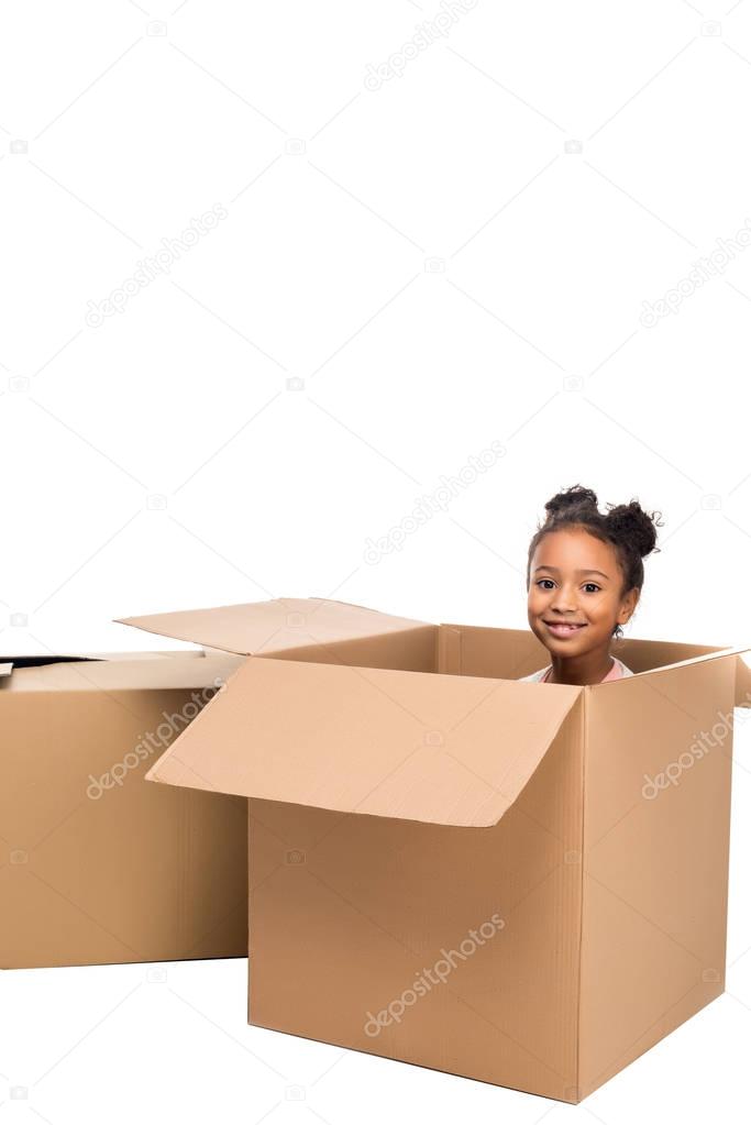 kid sitting in cardboard box