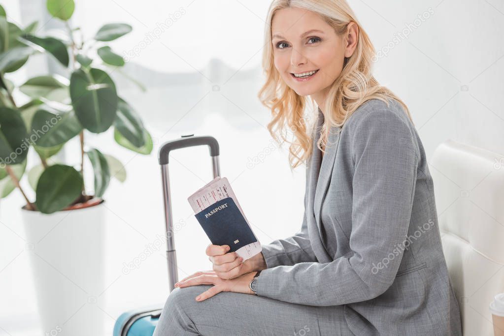 mature businesswoman with flight ticket