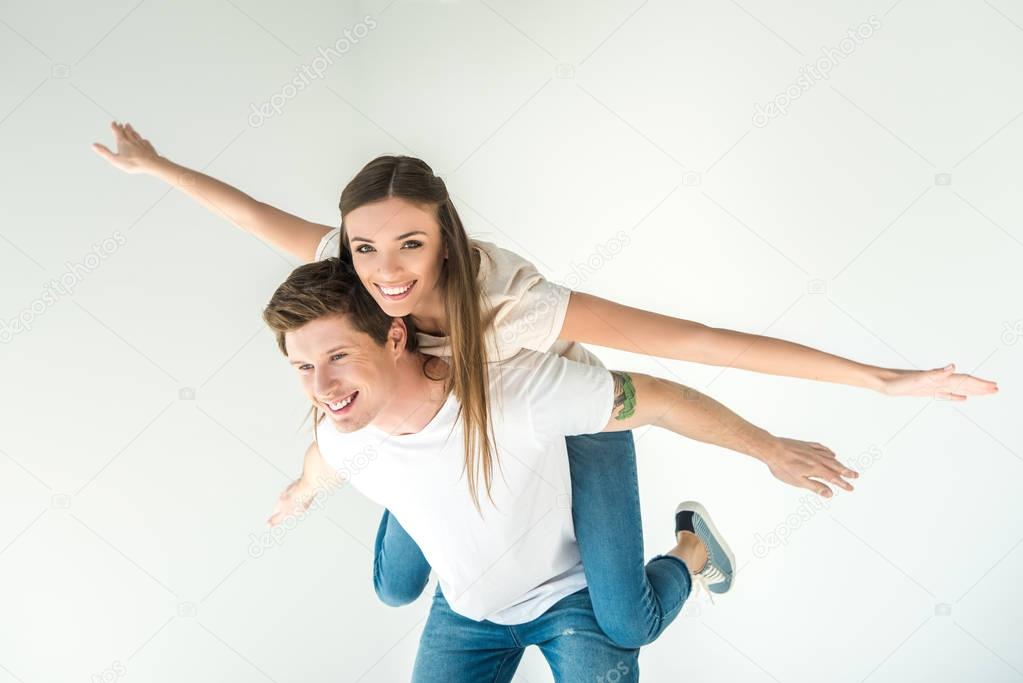 happy young couple piggybacking