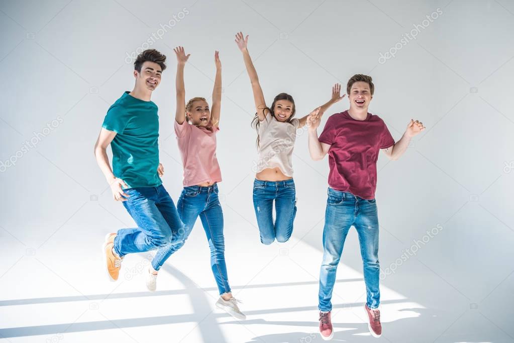 young people jumping together 