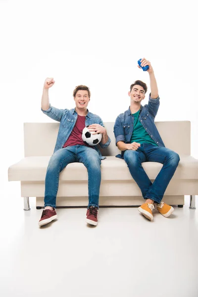 Friends with soccer ball on sofa — Stock Photo, Image