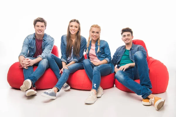 Friends sitting on bean bag chairs — Stock Photo, Image