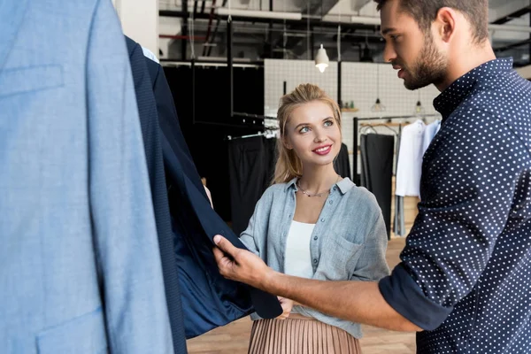 Couple choosing male clothes — Stock Photo, Image