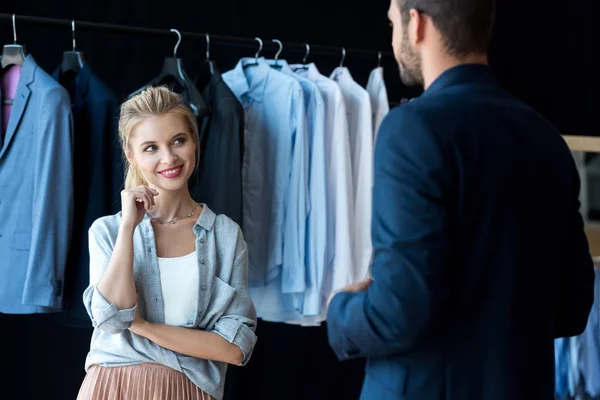 Couple choosing suit in boutique — Stock Photo, Image