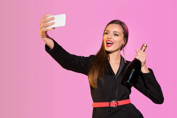 Happy woman with champagne taking selfie — Stock Photo, Image