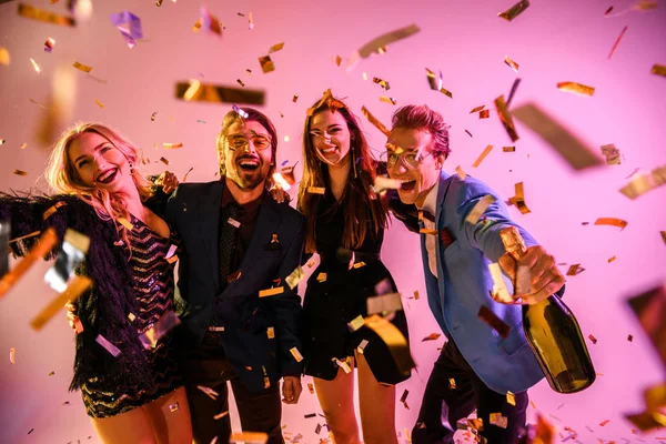 Excited friends on party with confetti — Stock Photo, Image