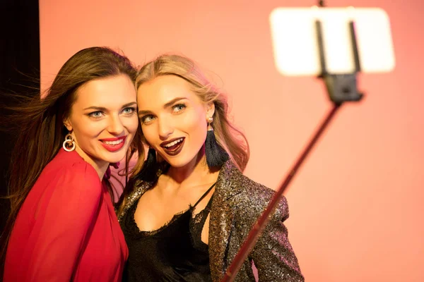 Glamorous girls taking selfie on smartphone — Stock Photo, Image