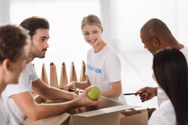 volunteers packing food for charity clipart