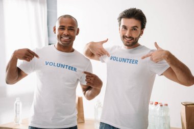 volunteers pointing at signs on t-shirts clipart