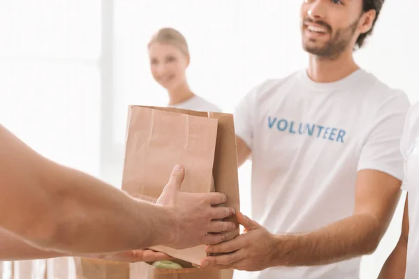 Volunteer taking charity package — Stock Photo, Image