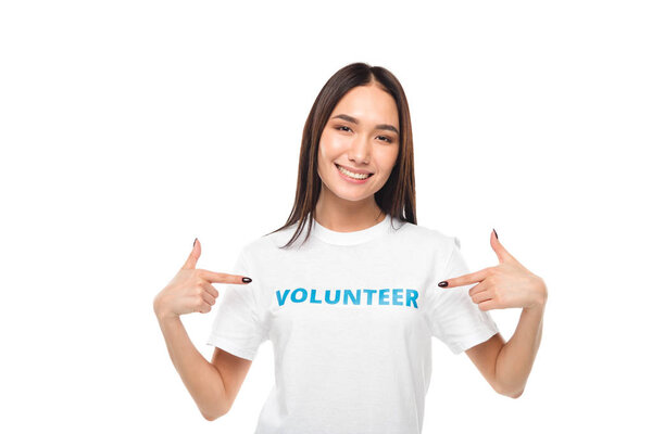volunteer pointing at sign on t-shirt
