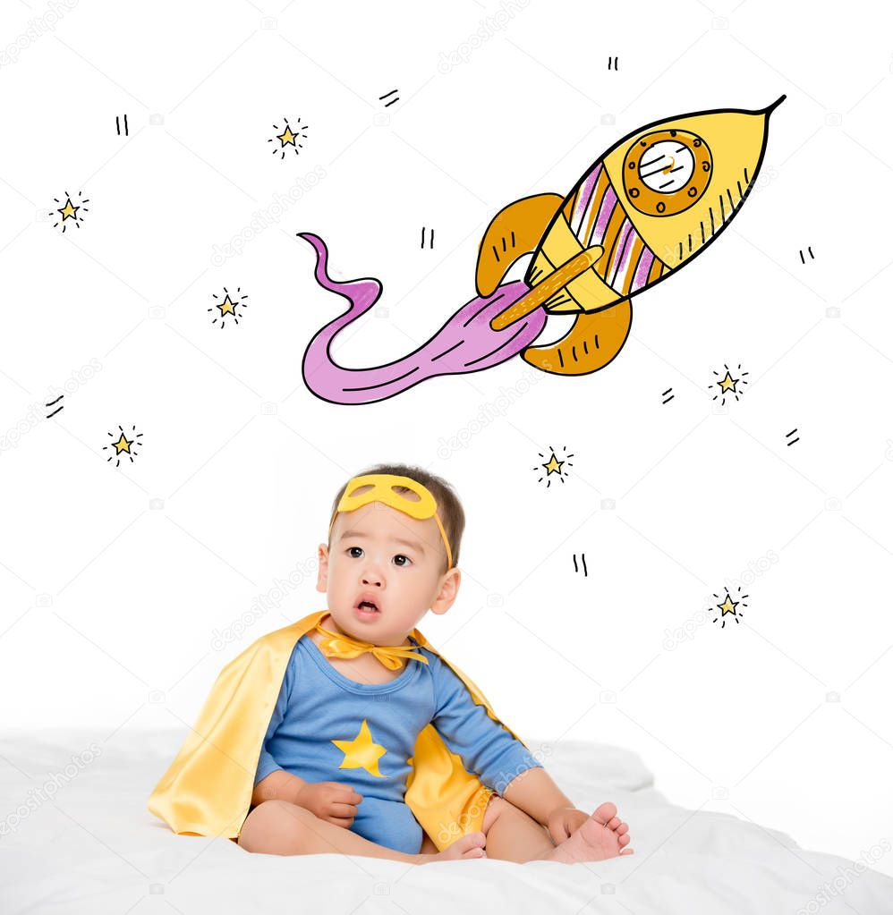 asian toddler in superhero cape