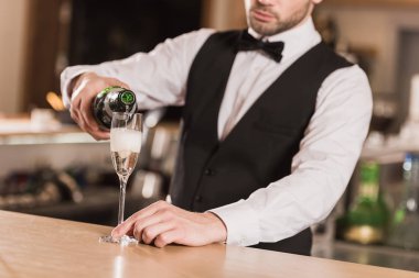 bartender pouring champagne into glass clipart