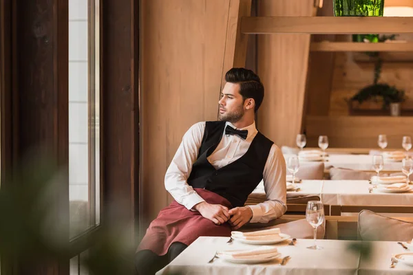 Waiter leaning on chair — Stock Photo, Image