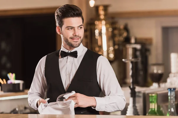 Bartender cleaning wineglass — Stock Photo, Image