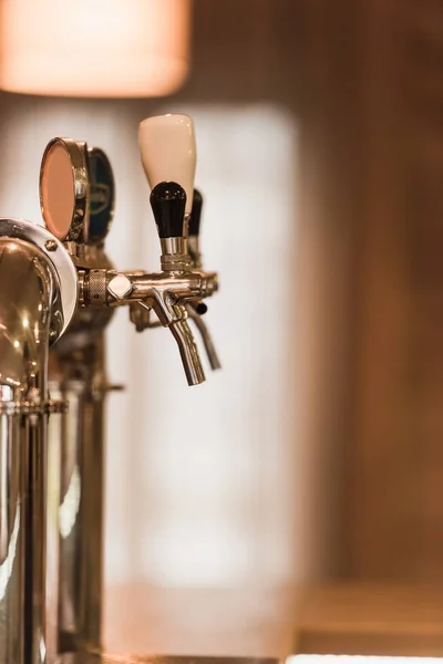 Beer taps at bar counter — 스톡 사진