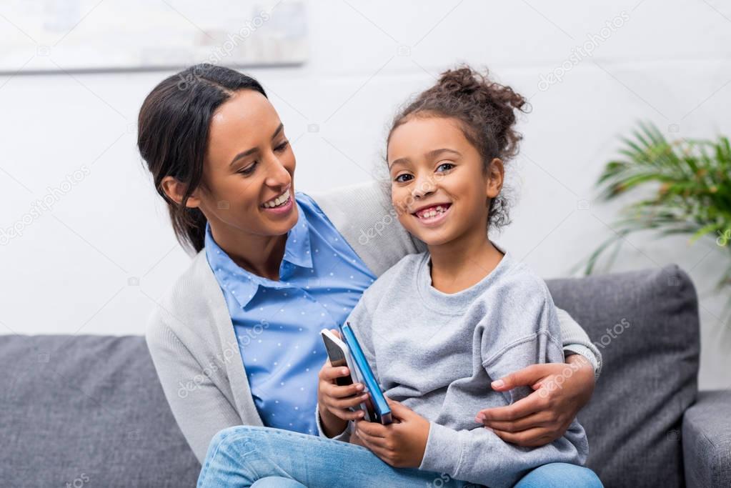 mother and daughter with smartphone 