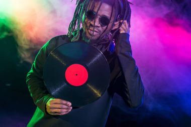 DJ with vinyl in nightclub  clipart