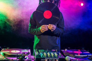 DJ with vinyl and sound mixer clipart