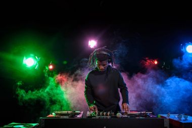 DJ in headphones with sound mixer clipart