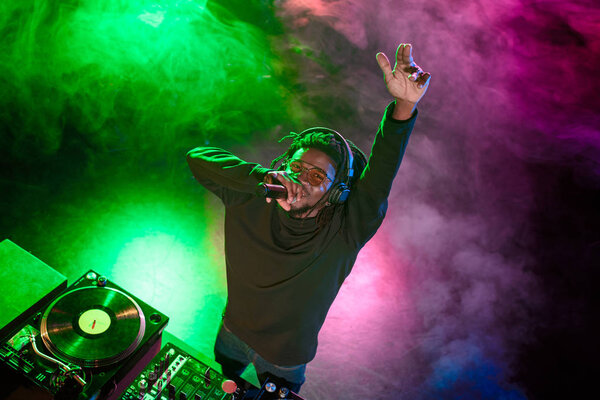 DJ with microphone in nightclub 