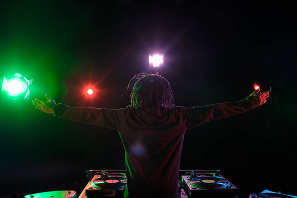 DJ with sound mixer in nightclub 
