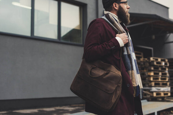 man in stylish clothing with leather bag