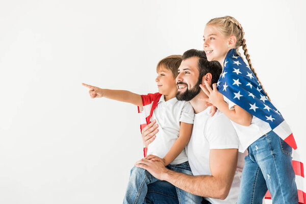 father and kids with american flag 