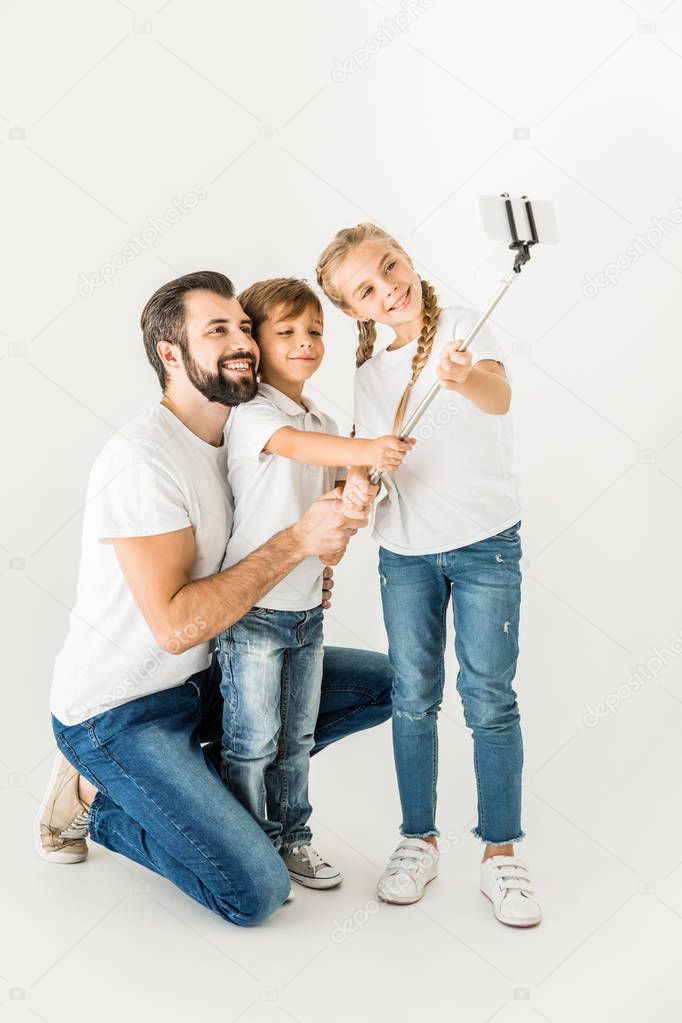 father with children taking selfie
