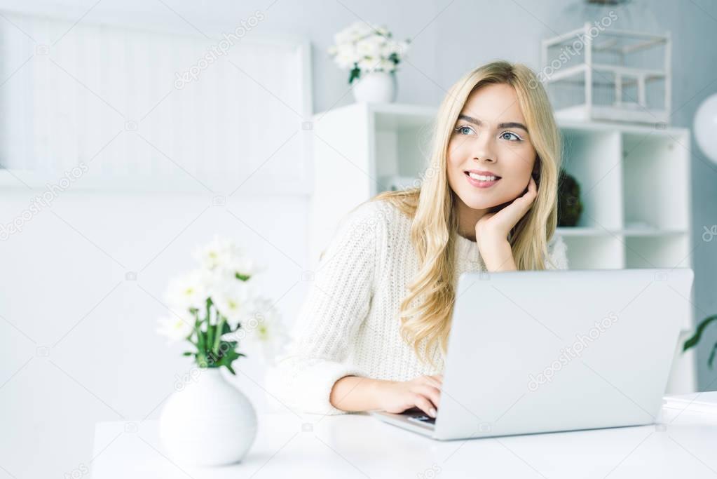 dreamy businesswoman working with laptop