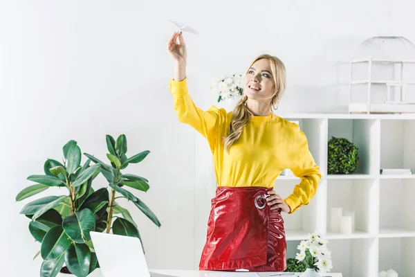 Businesswoman holding paper plane — Stock Photo, Image