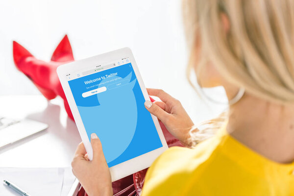 woman using tablet with twitter