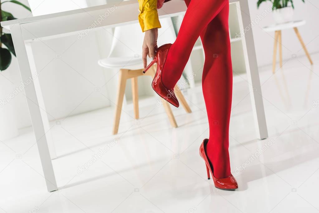 woman in red tights and heels