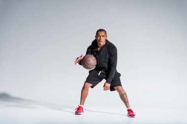basketbol topu ile oynama ve kameraya gri arıyorum sportif Afrikalı-Amerikalı adam