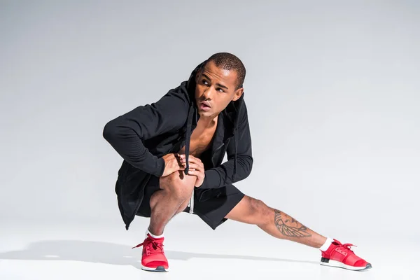 Young African American Man Sportswear Stretching Looking Away Grey — Stock Photo, Image