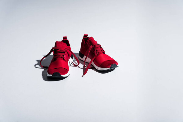 close-up view of red sneakers isolated on grey