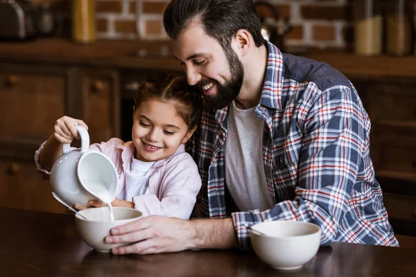 Father Daughter Pouring Milk Bowl Snacks Kitchen — Stock Photo, Image