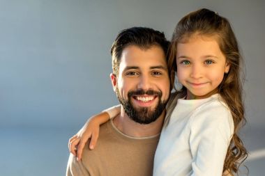 portrait of happy father and daughter looking at camera clipart