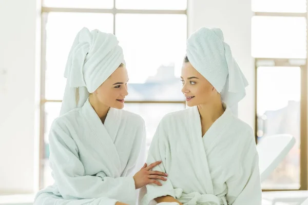 Beautiful Young Women Bathrobes Towels Head Talking Each Other Spa — Stock Photo, Image