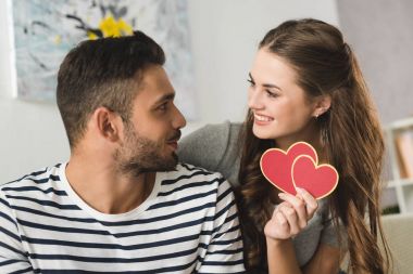 woman giving valentines day greeting card to boyfriend clipart