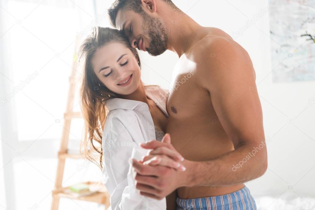 beautiful young couple dancing at home in morning