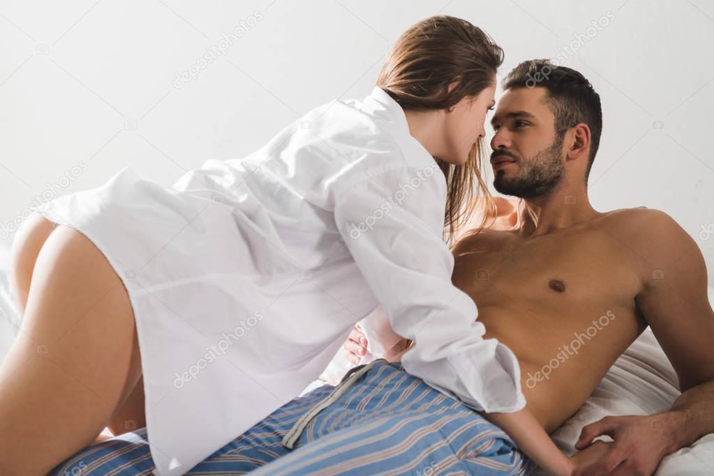 young passionate couple in bed at home