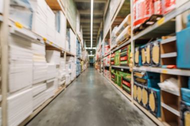 blurred view of shelves with boxes and styrofoam in warehouse clipart