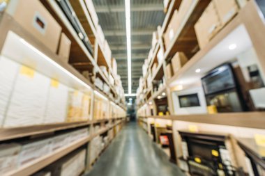 blurred view of shelves with boxes in warehouse clipart