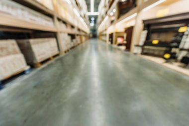 blurred view of shelves with boxes in warehouse clipart