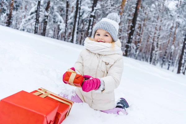 Happy Little Child Winter Clothes Sitting Snow Gift Boxes Smiling — Stock Photo, Image