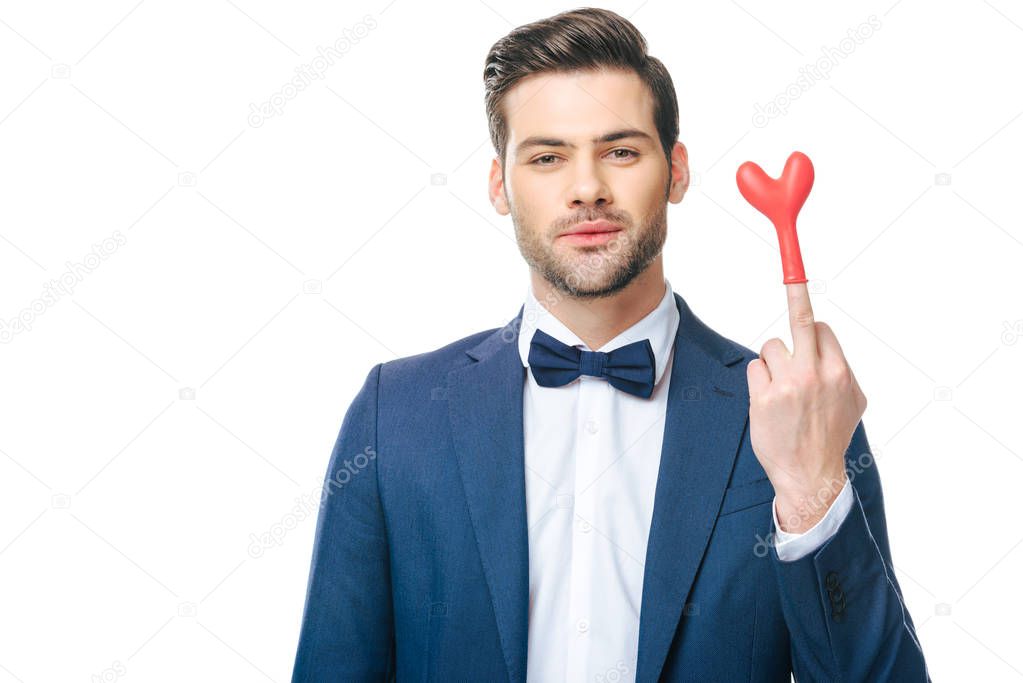 portrait of man in suit with heart shaped balloon on middle finger isolated on white