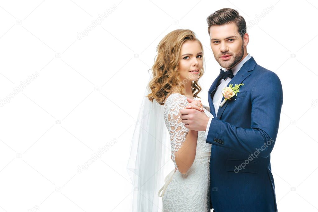 young bride and groom dancing together isolated on white