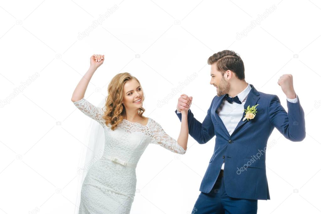 young bride and groom dancing together isolated on white